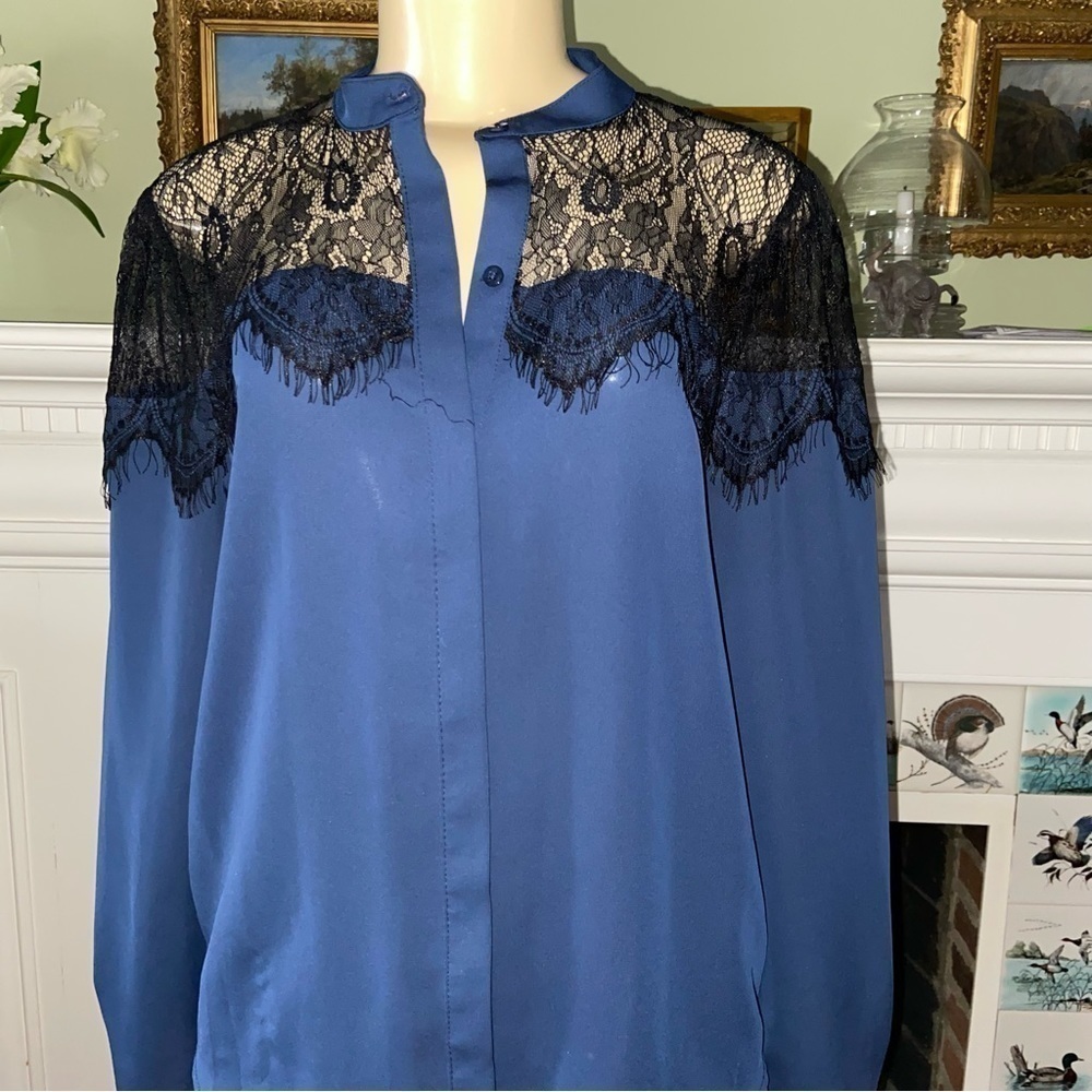 LAUREN Conrad classy navy blouse enhanced by lace shoulders and hidden buttons.
